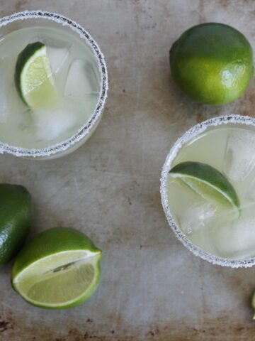 overhead view of margaritas on a metal surface