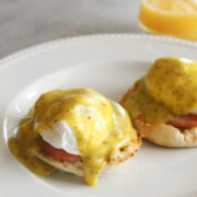 angled view of eggs Benedict on a white plate