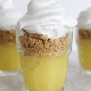 close up side view of lemon curd, graham cracker crust, and meringue layered in a shot glass