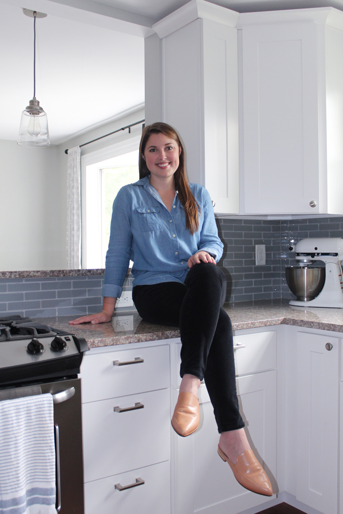 Allison sitting on counter in kitchen.