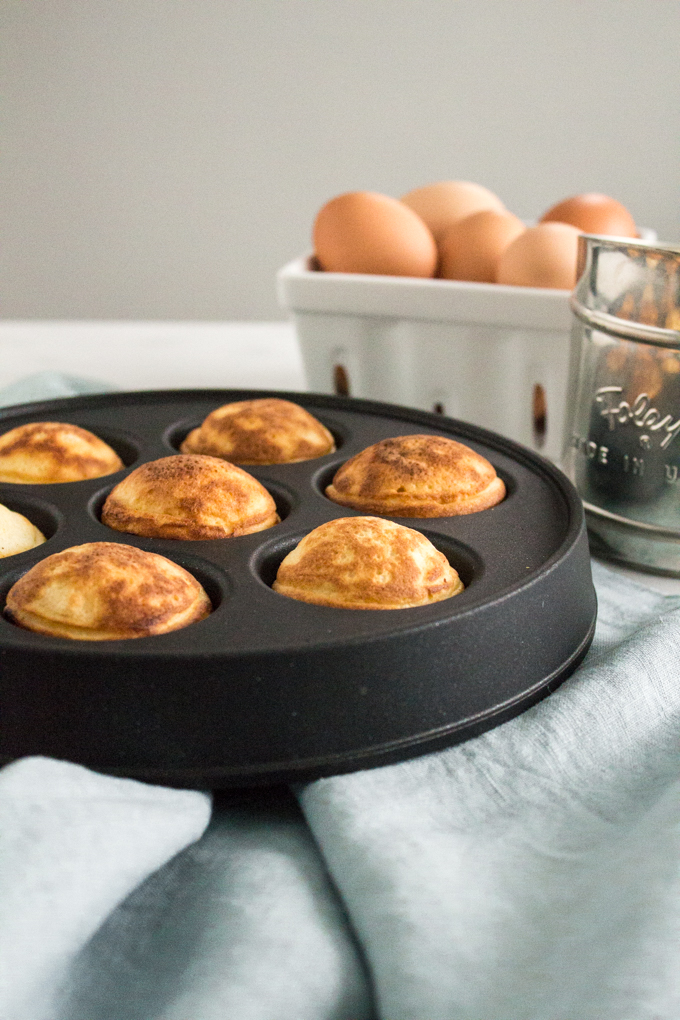 side view of Nutella-stuffed ebelskivers (Danish pancakes) in an ebelskiver pan