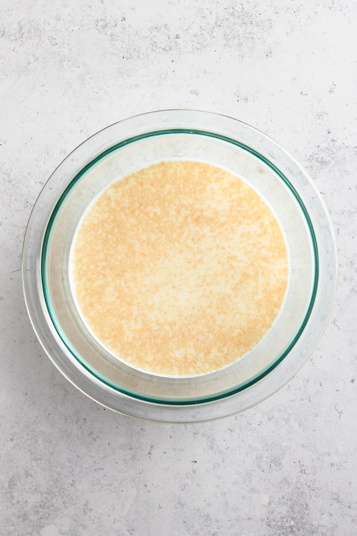 milk and foamy yeast in a glass bowl