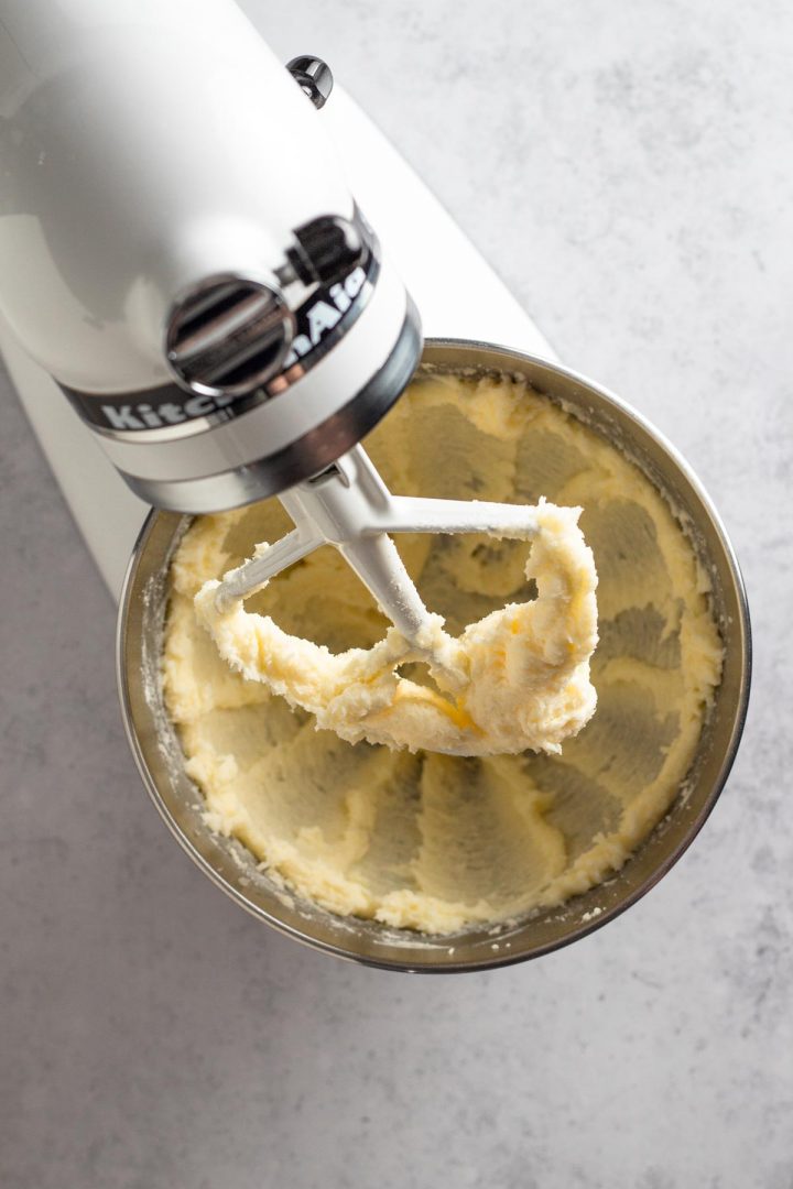 overhead view of creamed butter and sugar in a white stand mixer