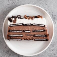 overhead view of a slice of icebox cake on a white plate