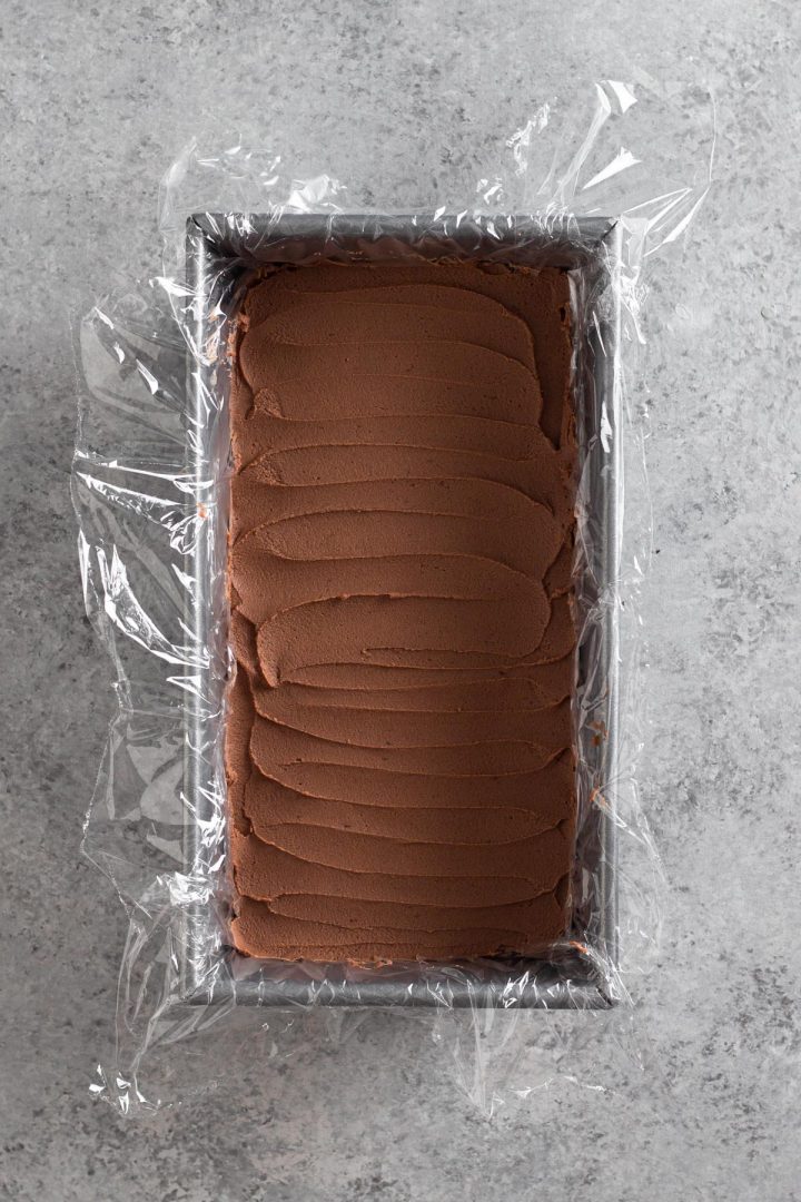 overhead view of loaf pan with a layer of chocolate peanut butter whipped cream