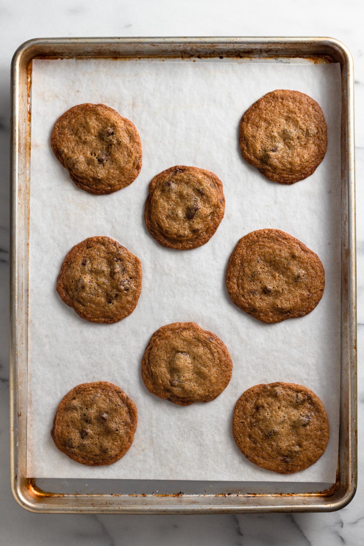 overhead view of baked chocolate chip cookies on a baking sheet