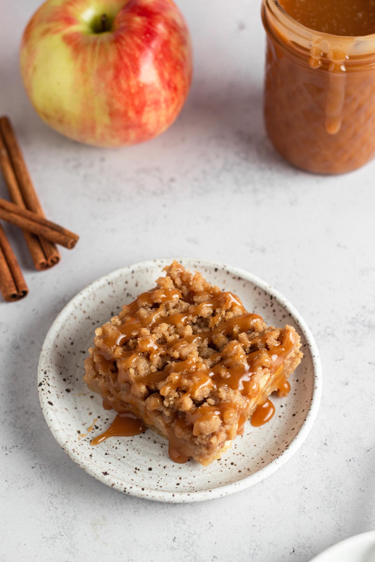 apple pie bar on a white plate drizzled with salted caramel sauce