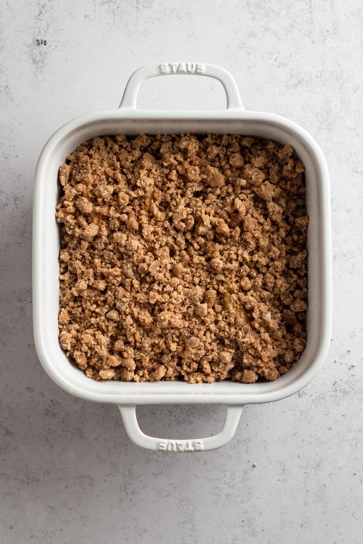 Streusel-topped bars in a white baking dish.