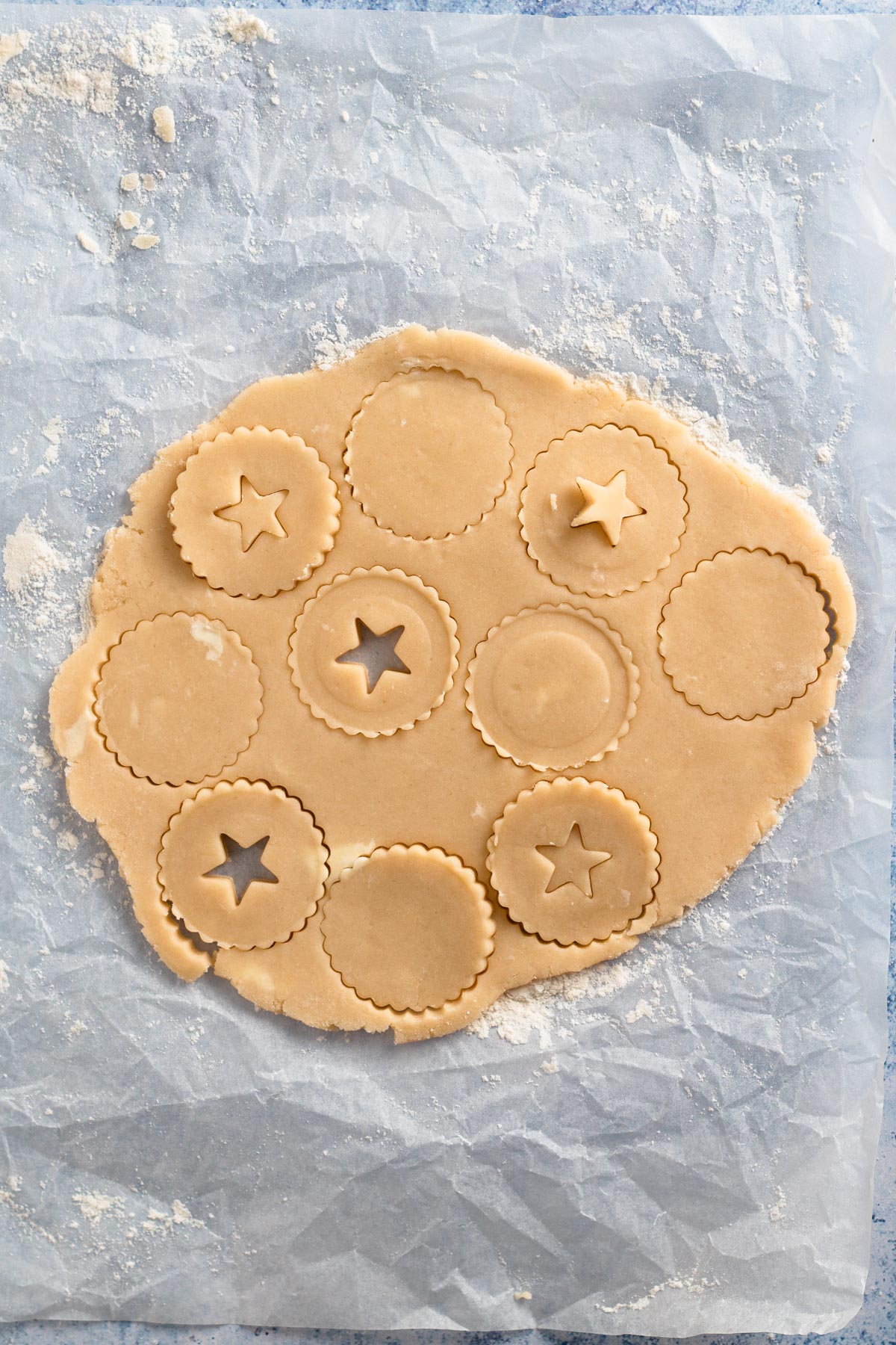 Overhead view of cut out cookie dough.