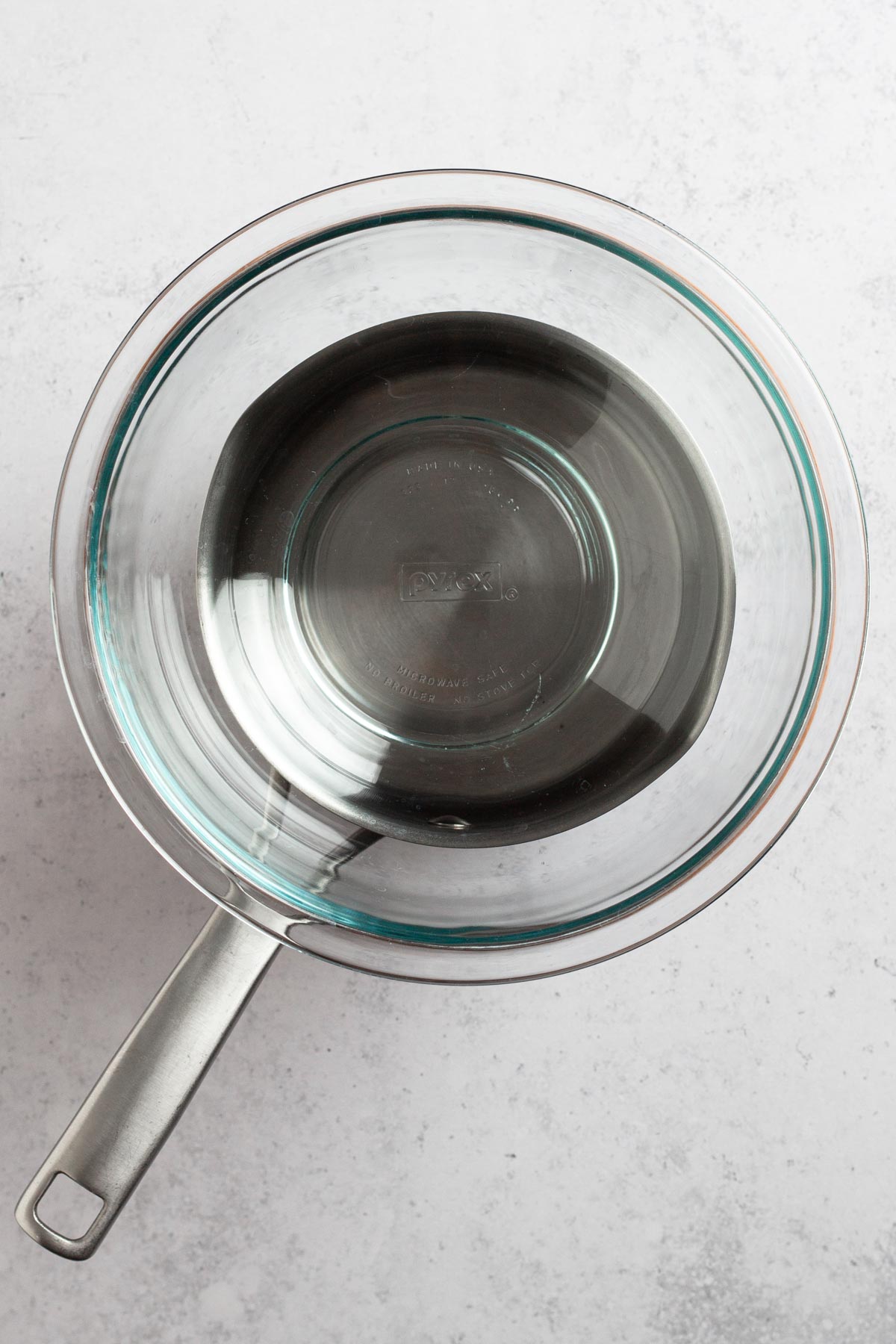 overhead view of glass bowl on saucepan