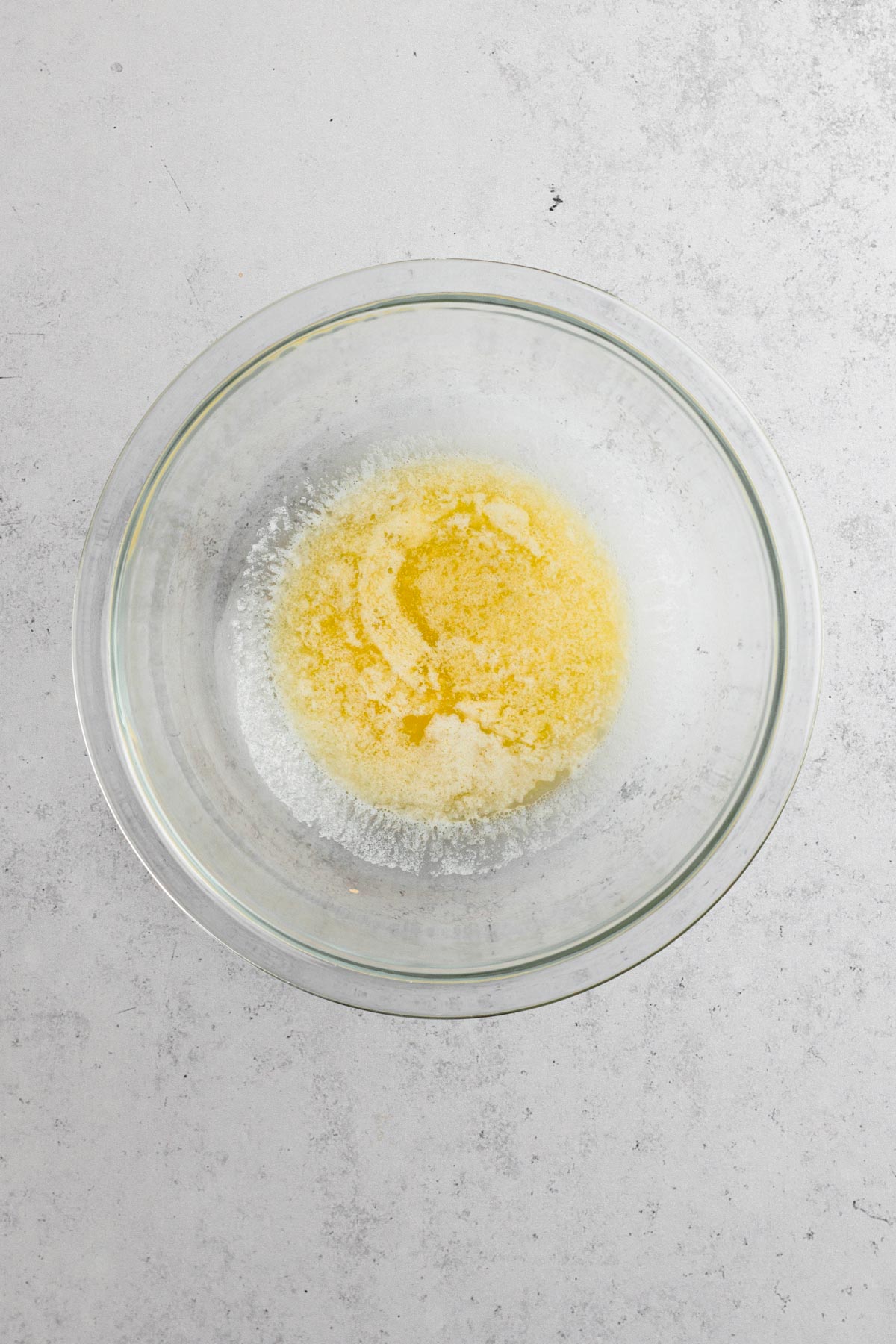 overhead view of melted butter in a glass bowl