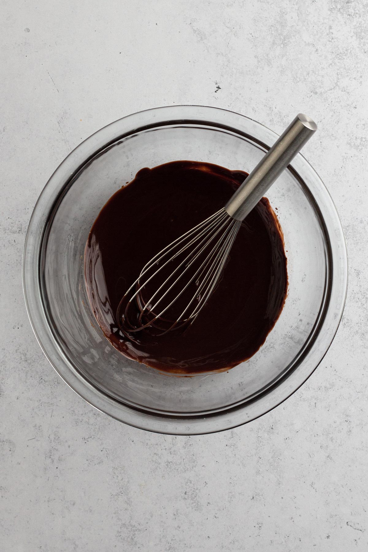 overhead view of melted chocolate in a glass bowl
