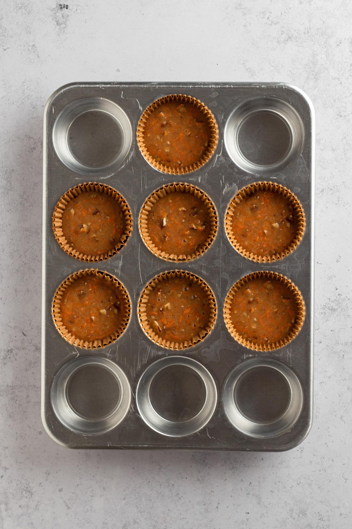 cupcake batter in liners in a muffin tin