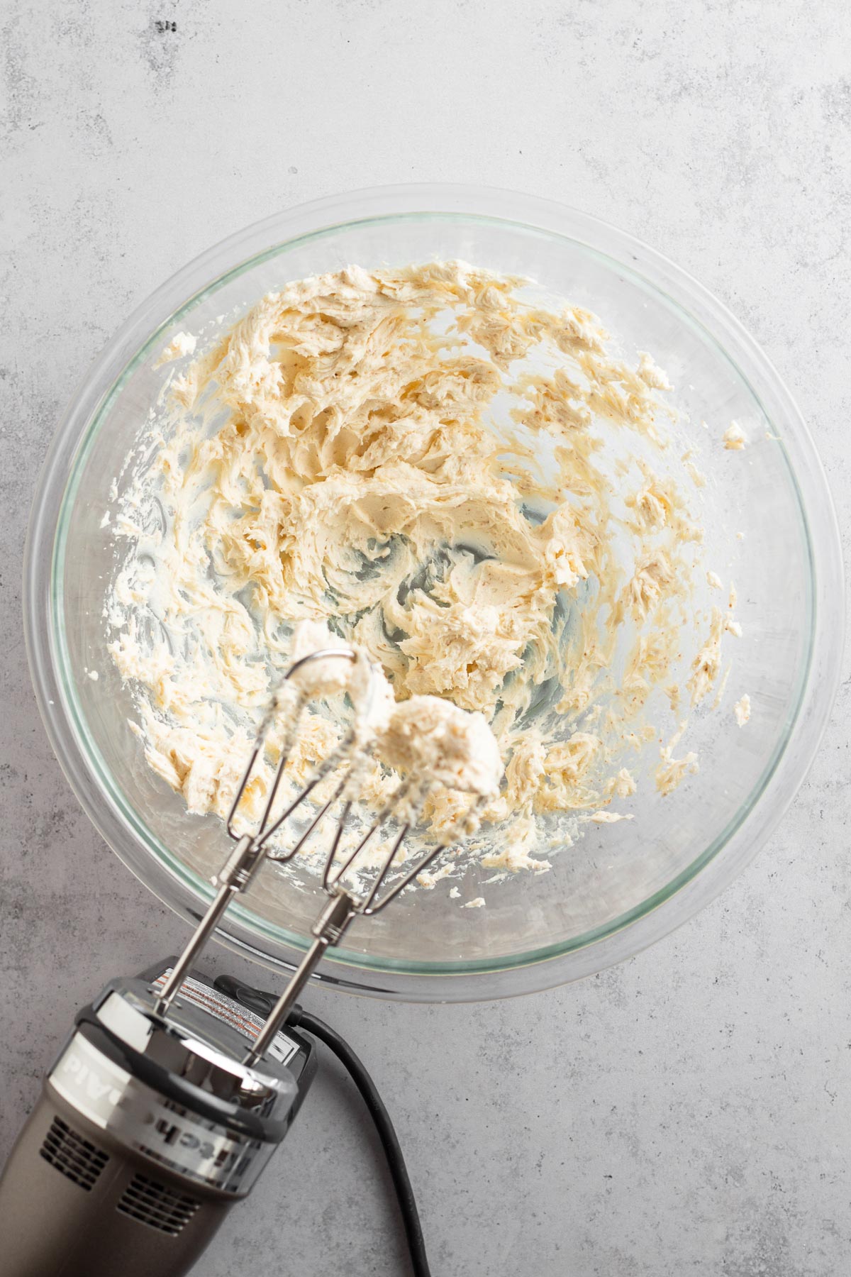 Whipped brown butter and cream cheese in a glass bowl.