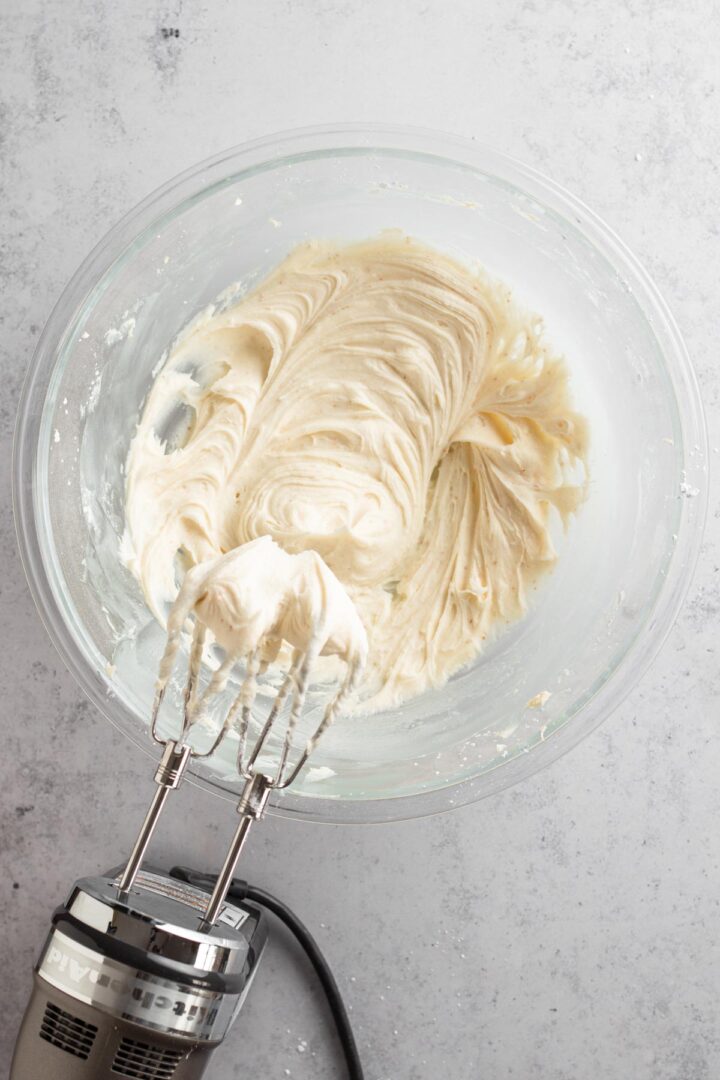 cream cheese frosting in a glass bowl