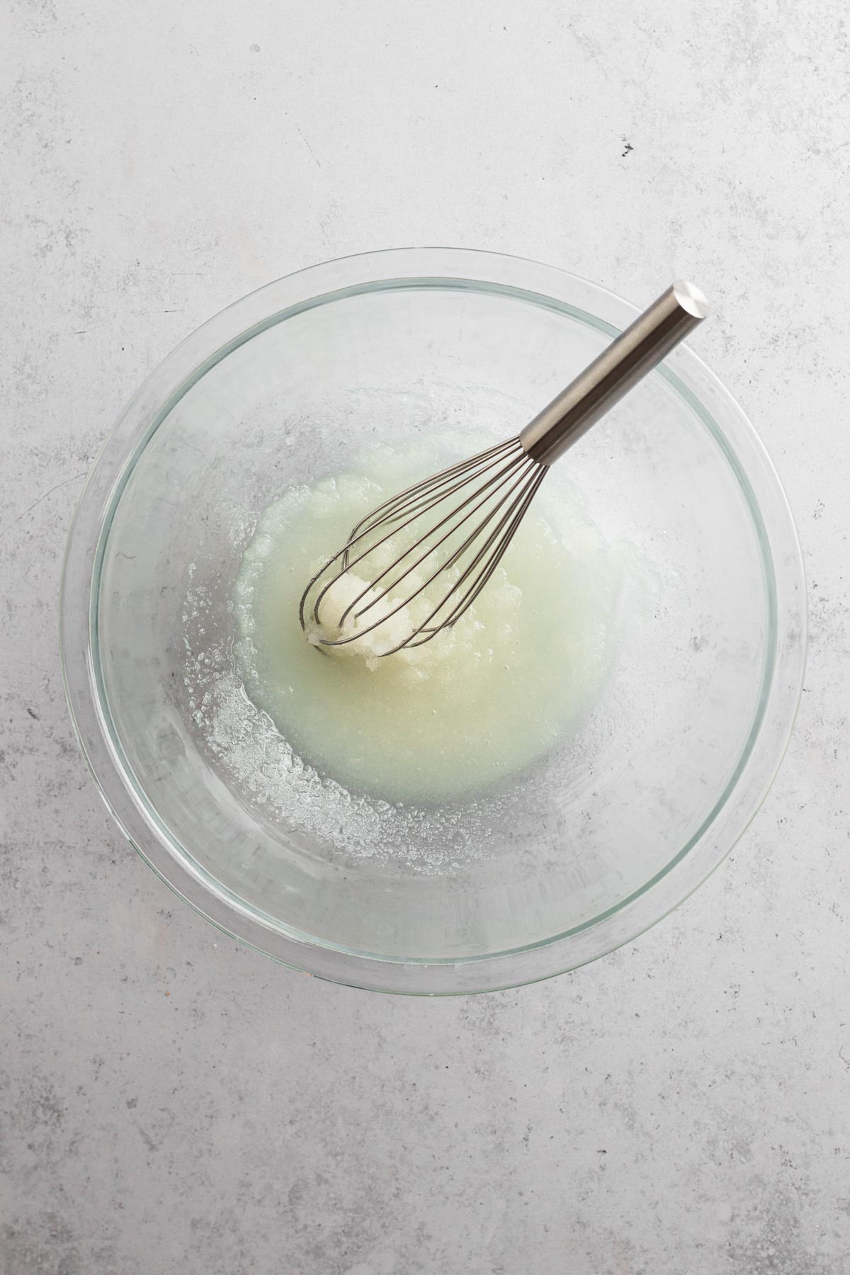 oil and sugar whisked together in a glass bowl