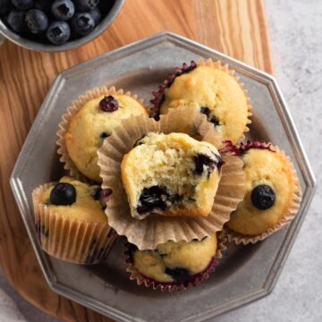 Stack of mini muffins on a metal plate.