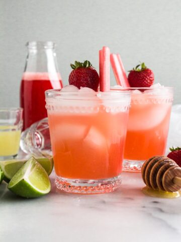 Margarita in a clear glass garnished with fresh fruit.