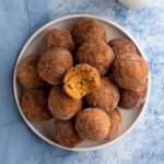 Stacked donut muffins on a white plate.