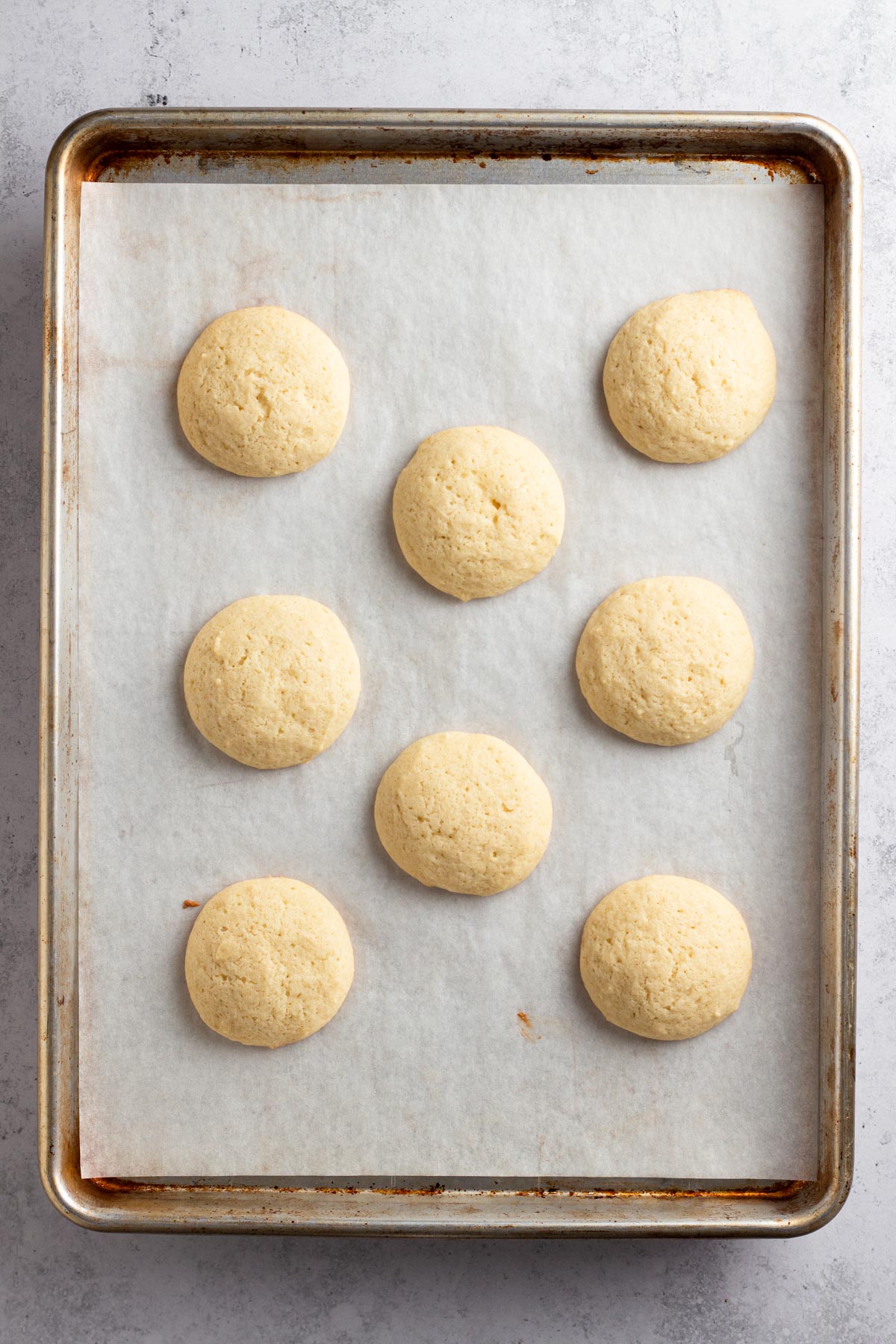 Baked cookies on a baking sheet lined with parchment paper.