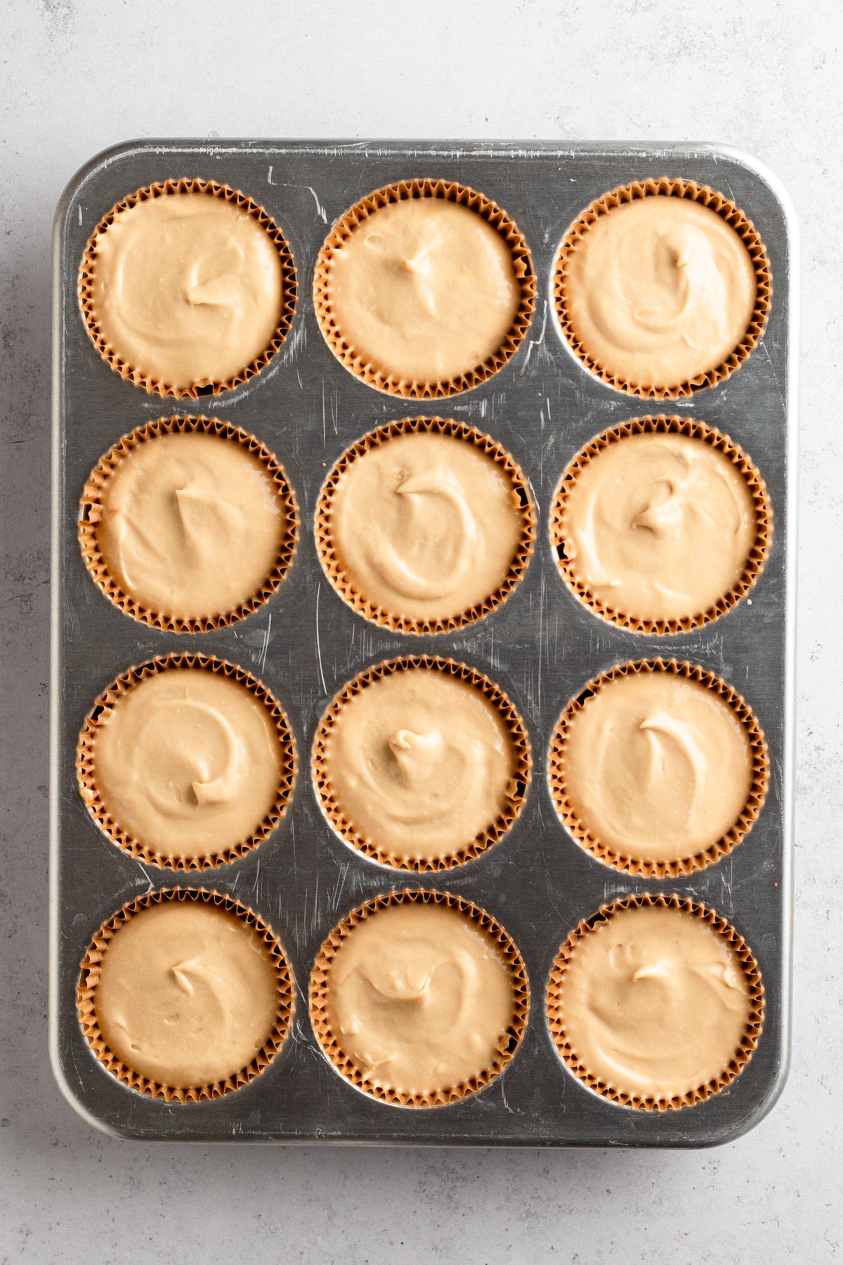 Cheesecake batter in muffin liners.