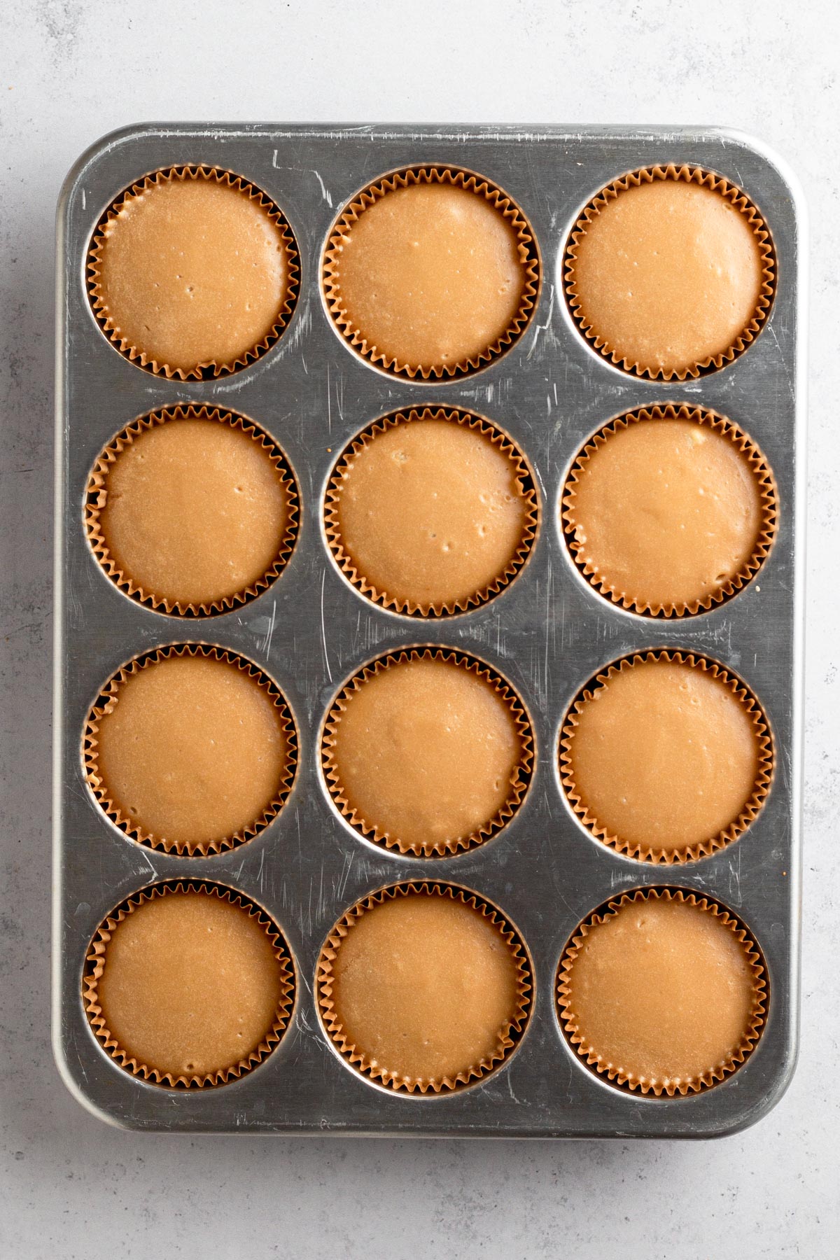 Baked mini cheesecakes in muffin pan.