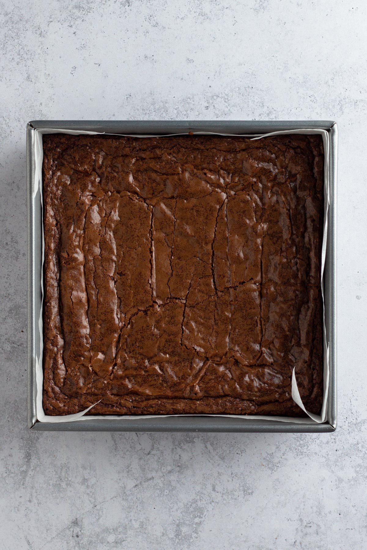 Baked brownies in a square metal pan.