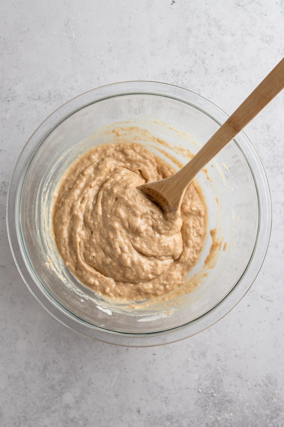 Overhead view of muffin batter in a glass bowl.