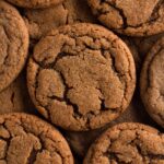 Molasses cookies with crinkle tops stacked on top of each other.