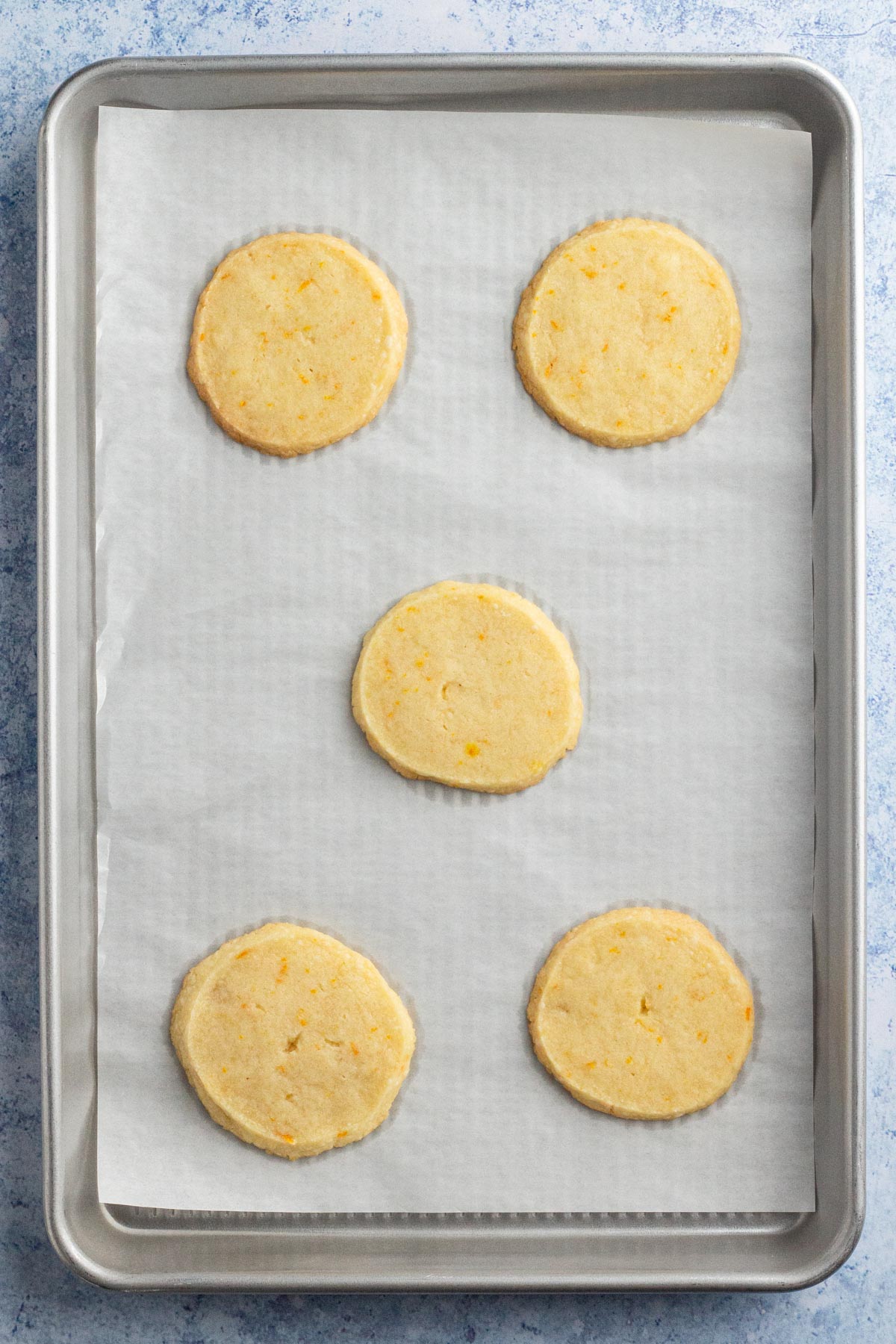 Baked cookies on a parchment-lined baking sheet.