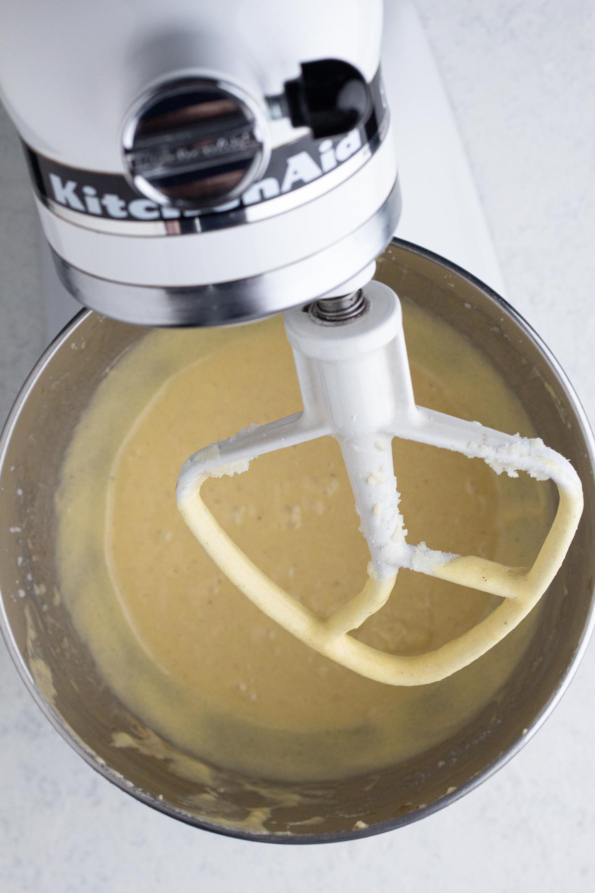 Wet ingredients in the bowl of a stand mixer.