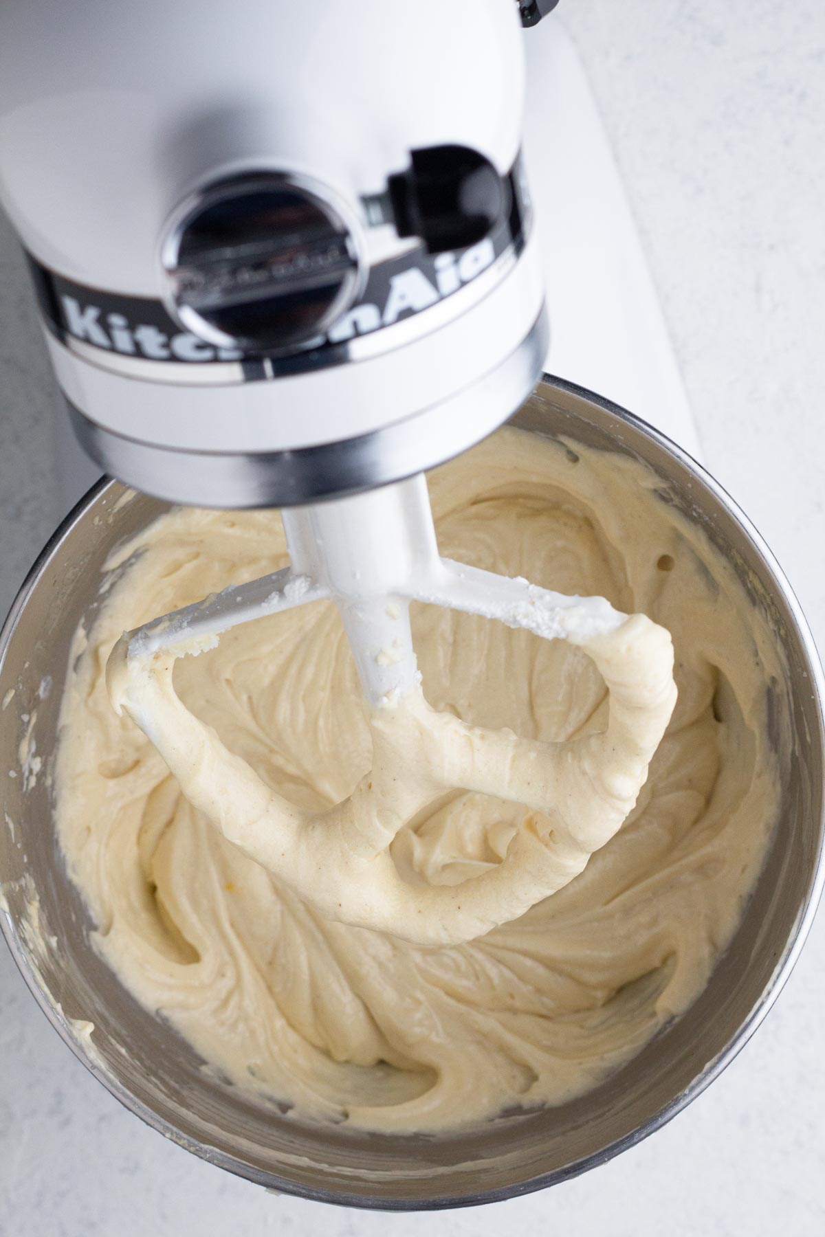 Cake batter in the bowl of a stand mixer.
