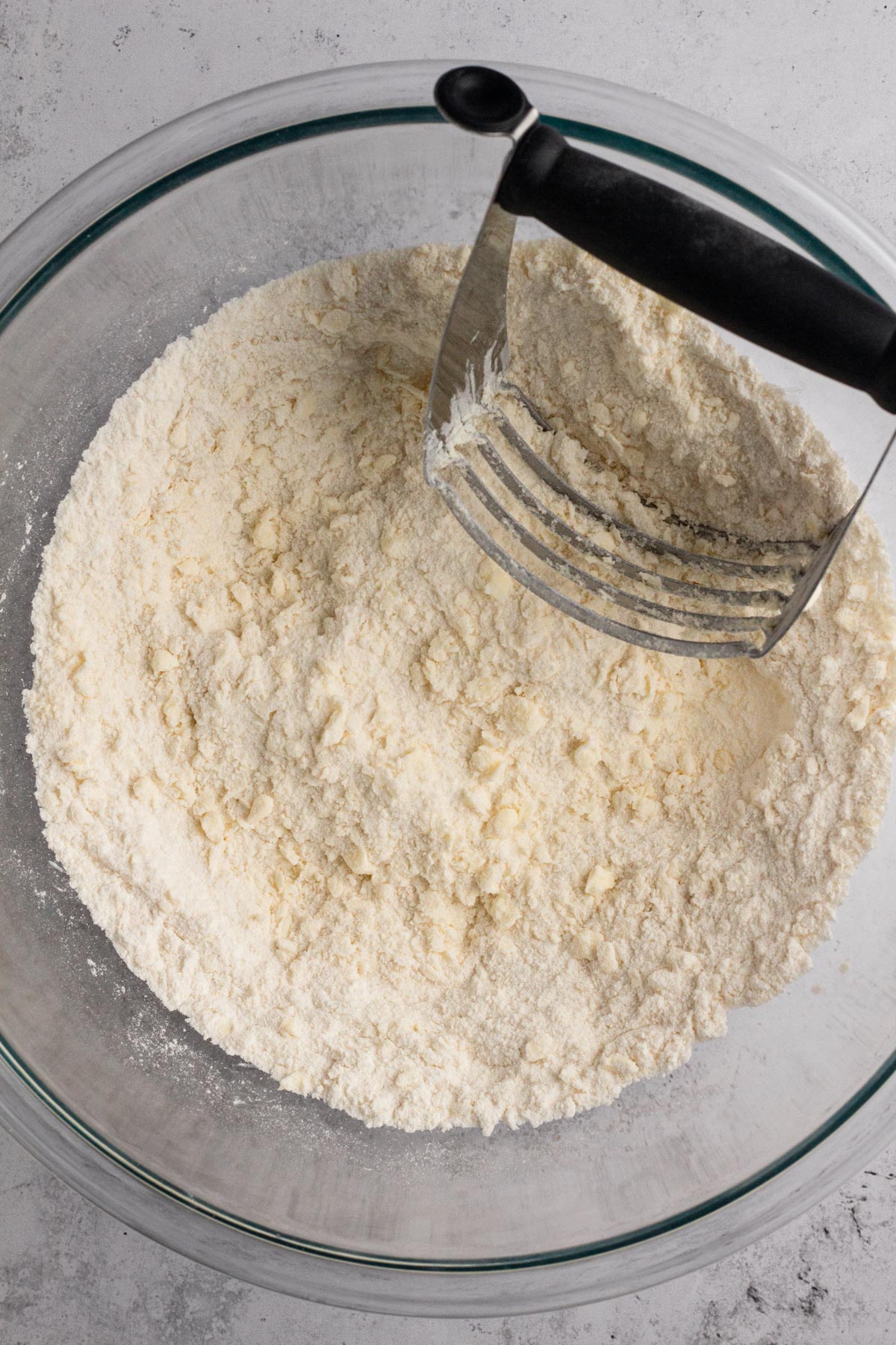 Butter cut into dry ingredients with a pastry cutter.