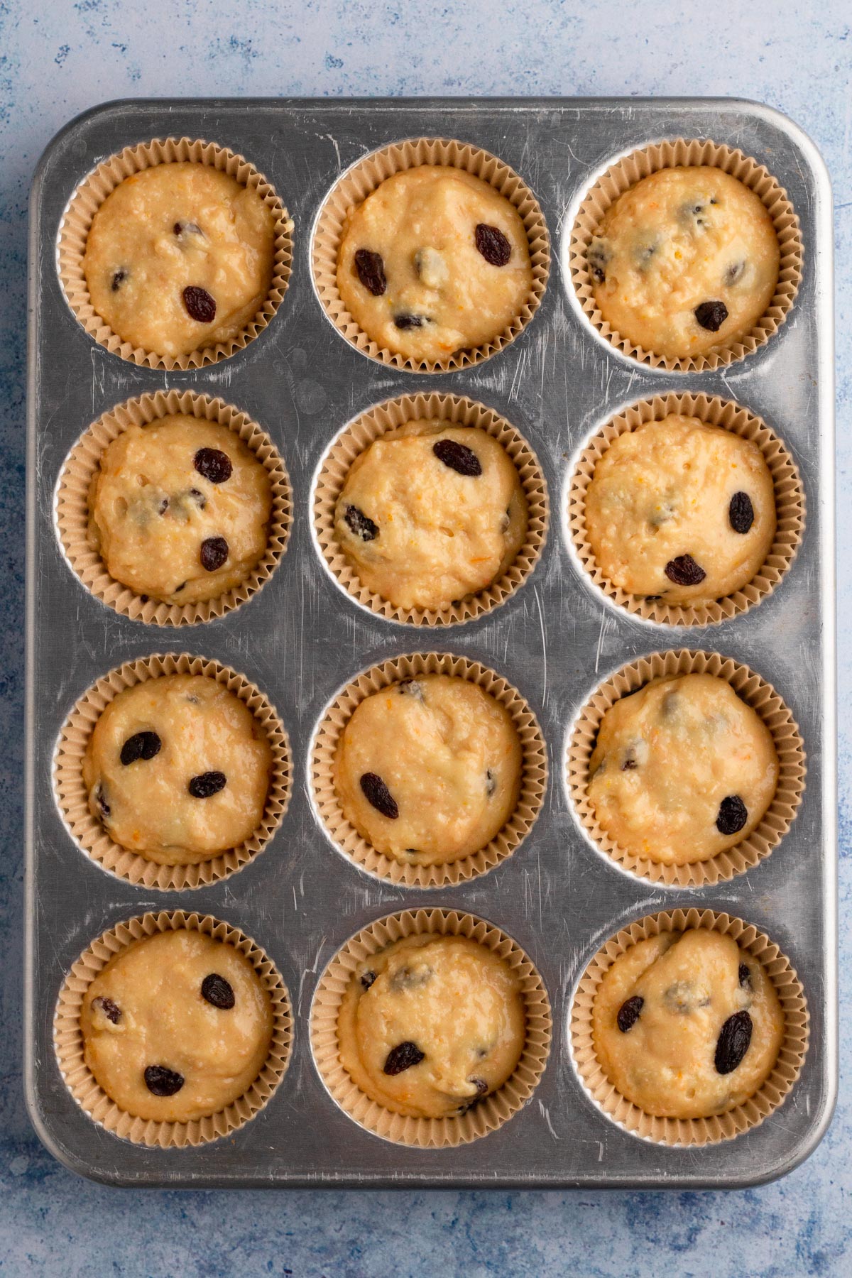 Muffin batter in a muffin pan.