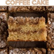Angled slice of coffee cake with crumb topping and a text overlay.