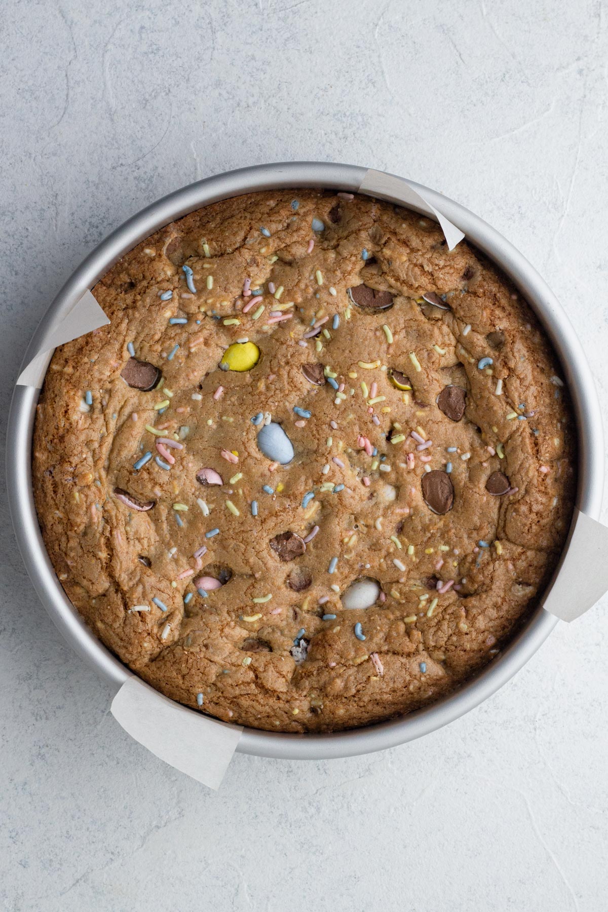 Baked cookie cake in round cake pan.