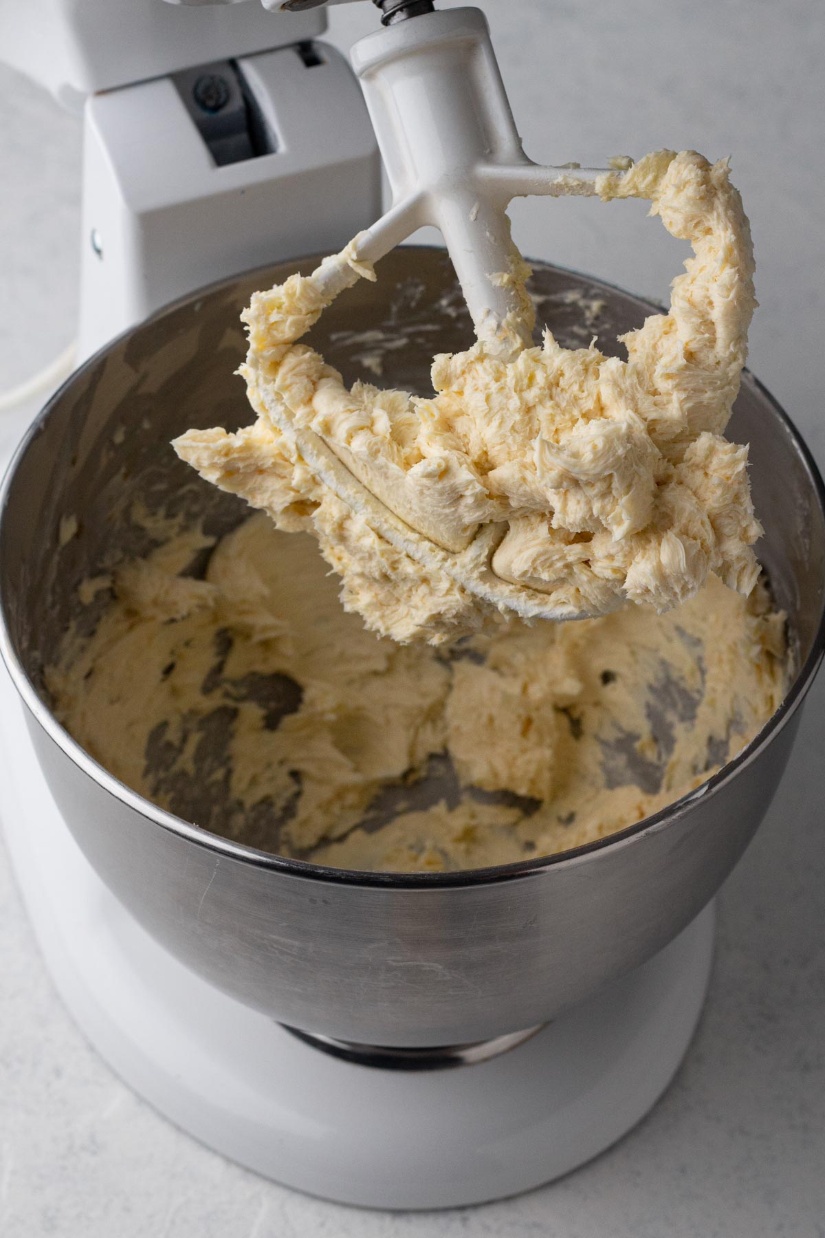 Beaten butter with confectioners' sugar in the bowl of a stand mixer.