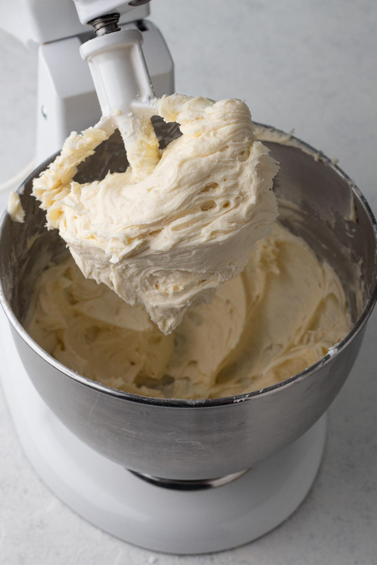 Eggnog buttercream frosting in the bowl of a stand mixer.