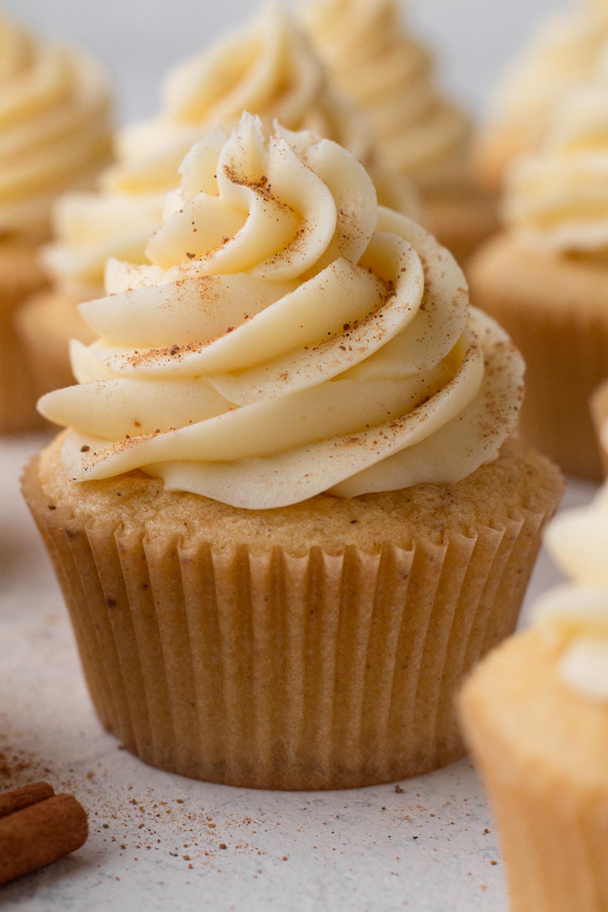 Eggnog frosting swirled on the top of a cupcake and sprinkled with ground nutmeg.