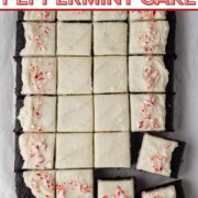 Overhead view of a sliced rectangular chocolate cake decorated with white frosting and crushed candy canes with a text overlay.