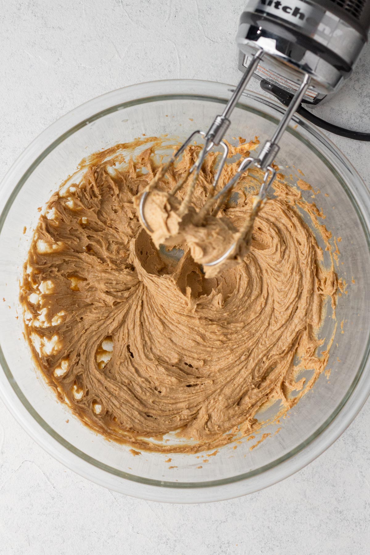 Wet ingredients blended together in a glass mixing bowl.