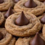 Stacked cookies topped with chocolate kisses.