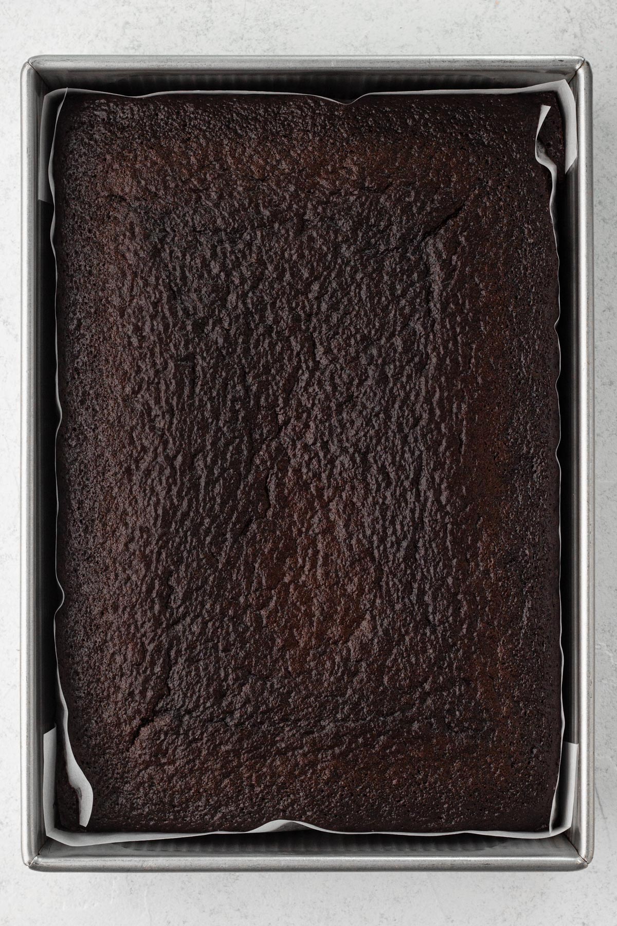 Baked chocolate cake in a 9x13 pan.