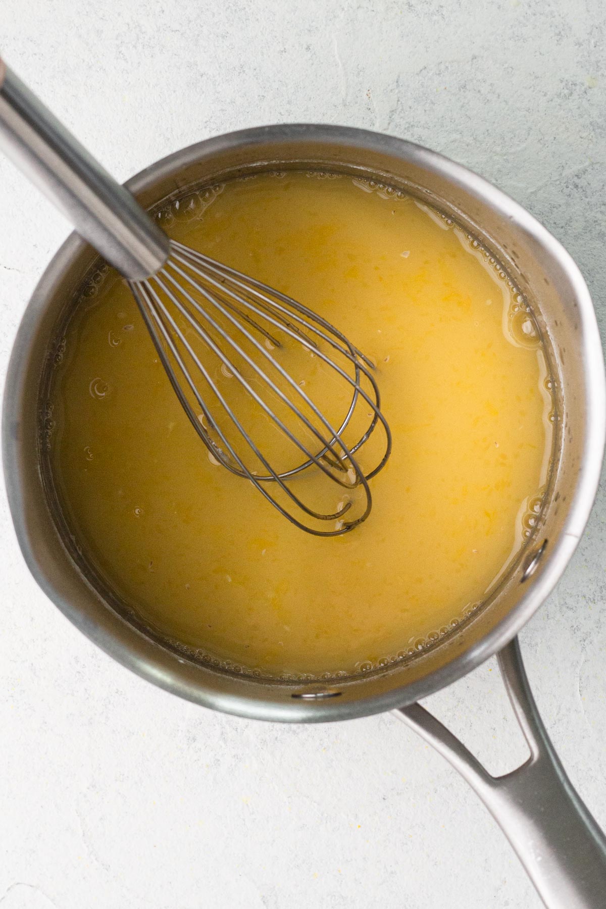 Glaze ingredients in a small saucepan with a metal whisk.