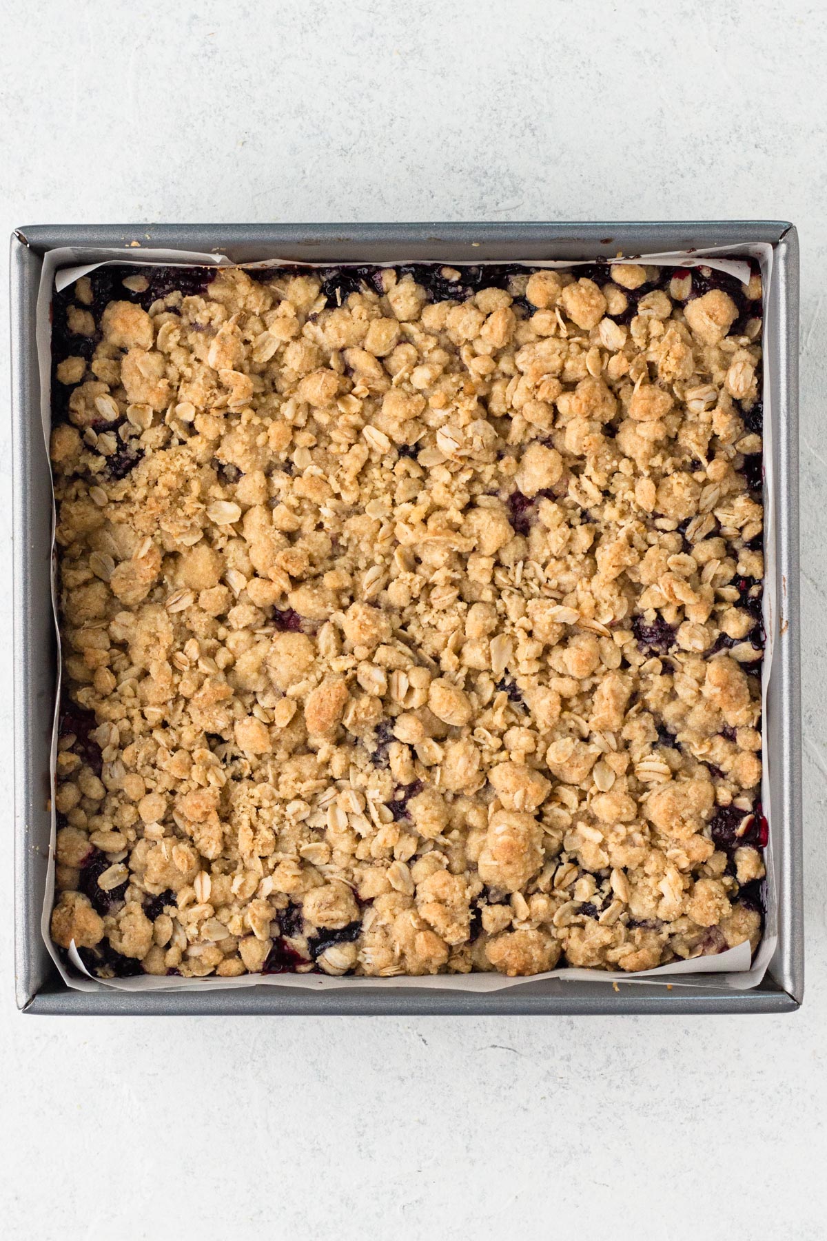 Baked bars in a square metal baking pan.