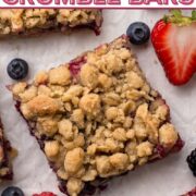 Bars filled with fruit and topped with crumble surrounded by pieces of fresh fruit with a text overlay.