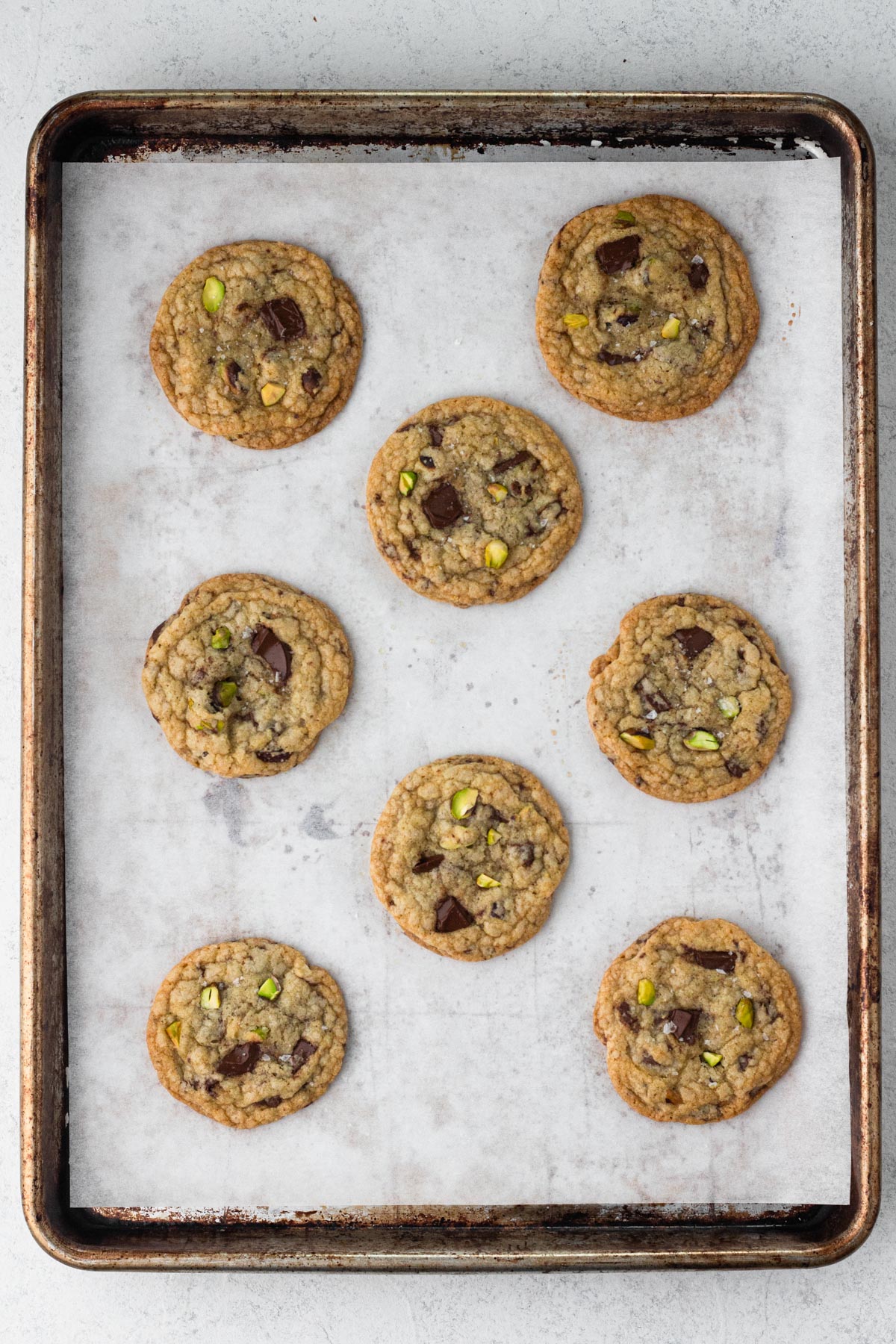 Baked cookies on a baking sheet lined with parchment paper.