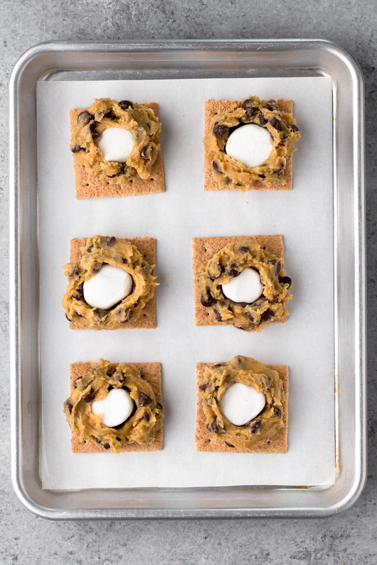 S'mores topped with cookie dough on a baking sheet.