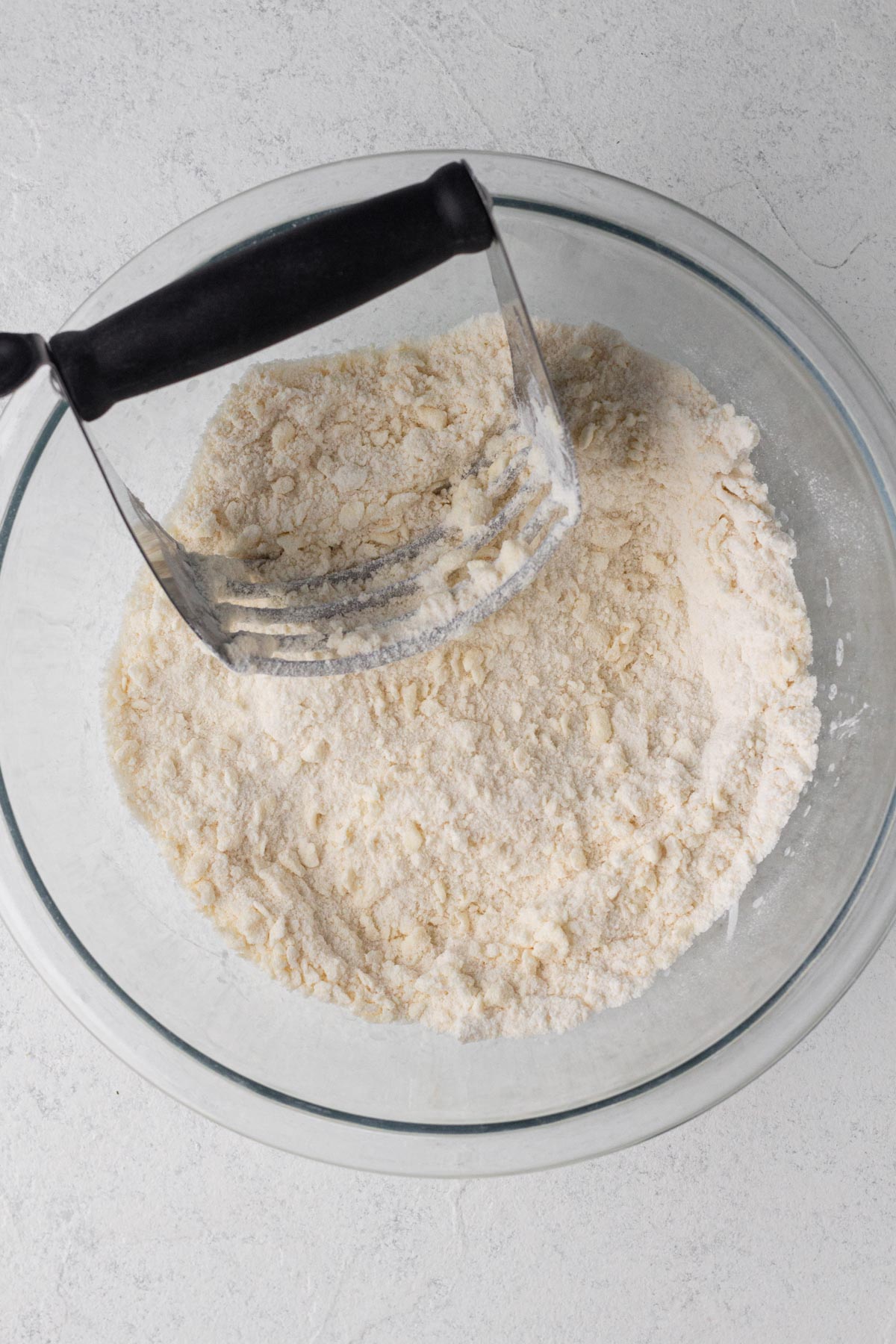 Butter cut into flour mixture with a pastry blender.