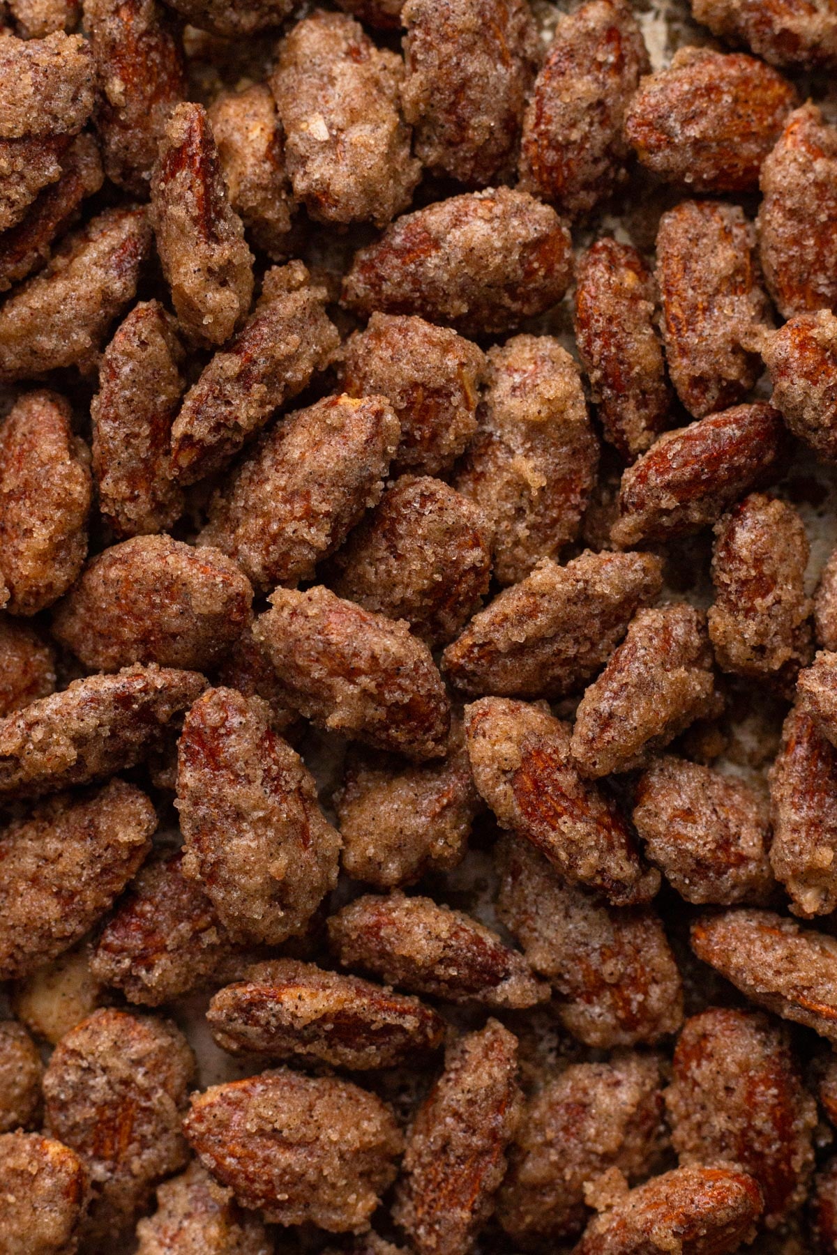A pile of candied almonds coated in cinnamon sugar.